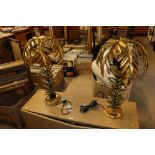 A pair of decorative gilt table lamps in the form