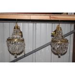 Two brass hanging light fittings with glass prism