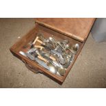 An oak box containing military flatware