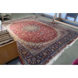 An approx. 13'9" x 9'10" red patterned rug