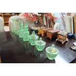 A collection of green glass dressing table items