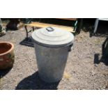 A galvanised dustbin and lid