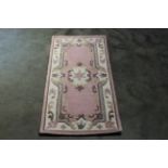 An approx. 2'9" x 2' Chinese style patterned rug