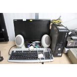 A Dell computer, keyboard, monitor, speakers and m