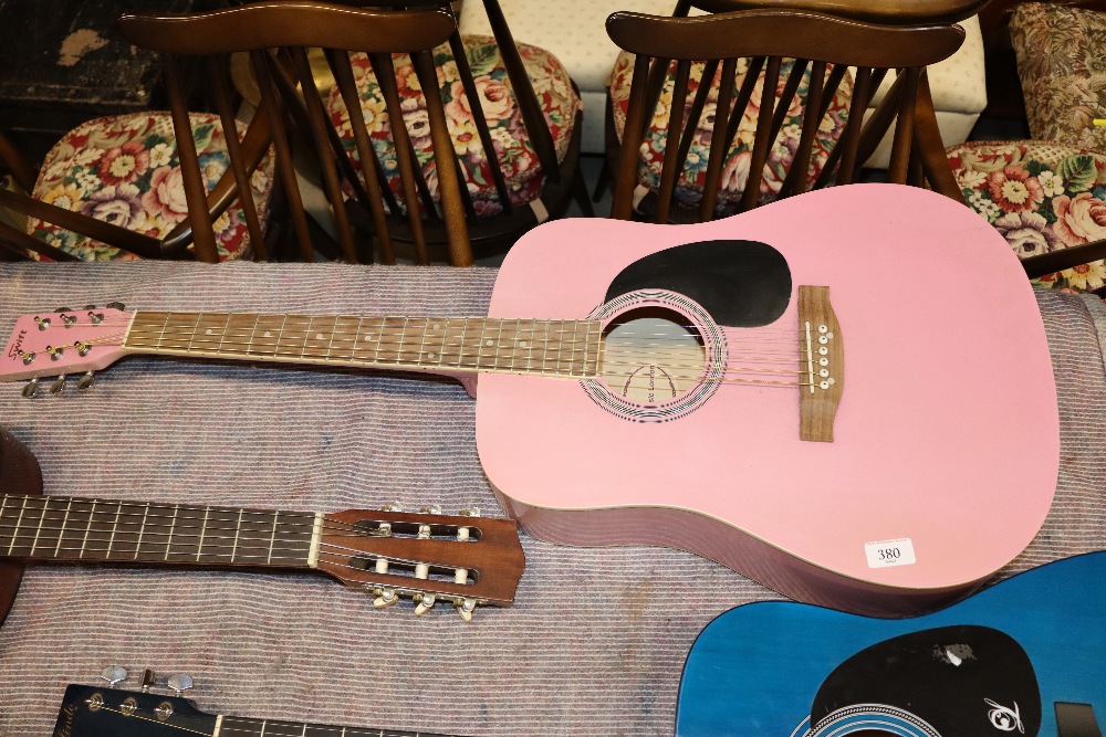 A Swift pink acoustic guitar