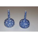 A pair of floral decorated blue and white vases