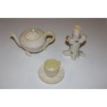 A green stamp Belleek tea pot in the form of a she