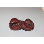 A carved wooden Netsuke in the form of a snake