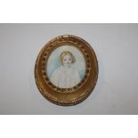 A gilt framed miniature depicting a young girl, in