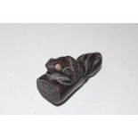 A carved wooden Netsuke