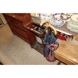 A cast iron stick stand and contents, and an oak s
