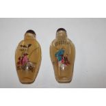 A pair of Oriental decorated snuff bottles