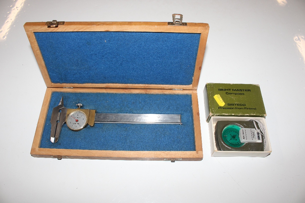 A Sitemaster compass with original; box; and a mic
