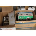 Two boxes containing records and Giles annuals etc