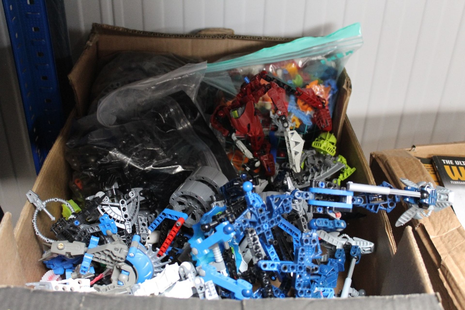 A box of Bionicle figures etc.