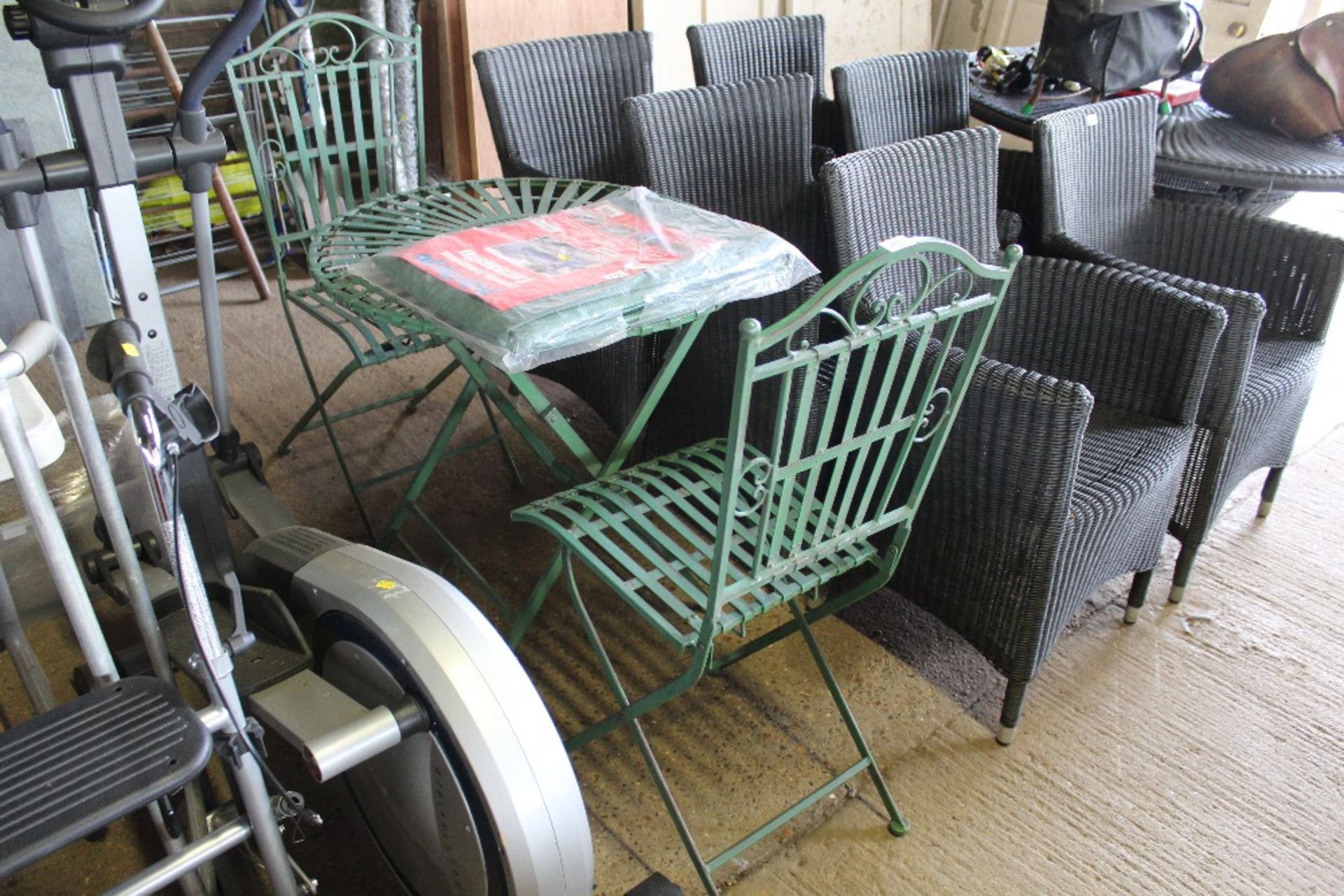 An ornate metal folding garden table and two matchi