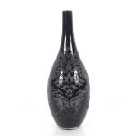 A black glass vase with leaf etching, 53cm high