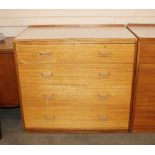 A teak and laminate chest of two short and three l