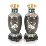 A pair of cloisonné baluster vases on black wood s