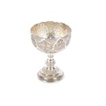 A Persian white metal goblet with raised and pierc