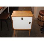 A pine and laminate bedside cabinet by Alfred Cox,