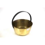 An antique brass jam pan with iron loop handle