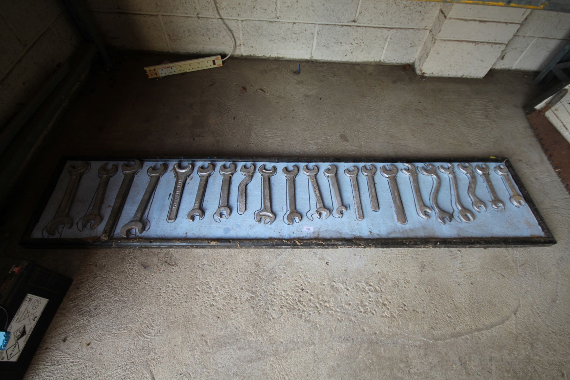 Twenty one spanners mounted on a board