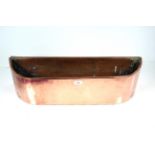 A bow fronted copper planter