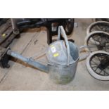 A galvanised 1 gallon watering can