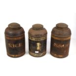 A Toleware tea canister and two Toleware storage t