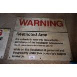 A military warning sign "Warning Restricted Area",