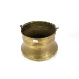 A brass bucket with iron swing handle