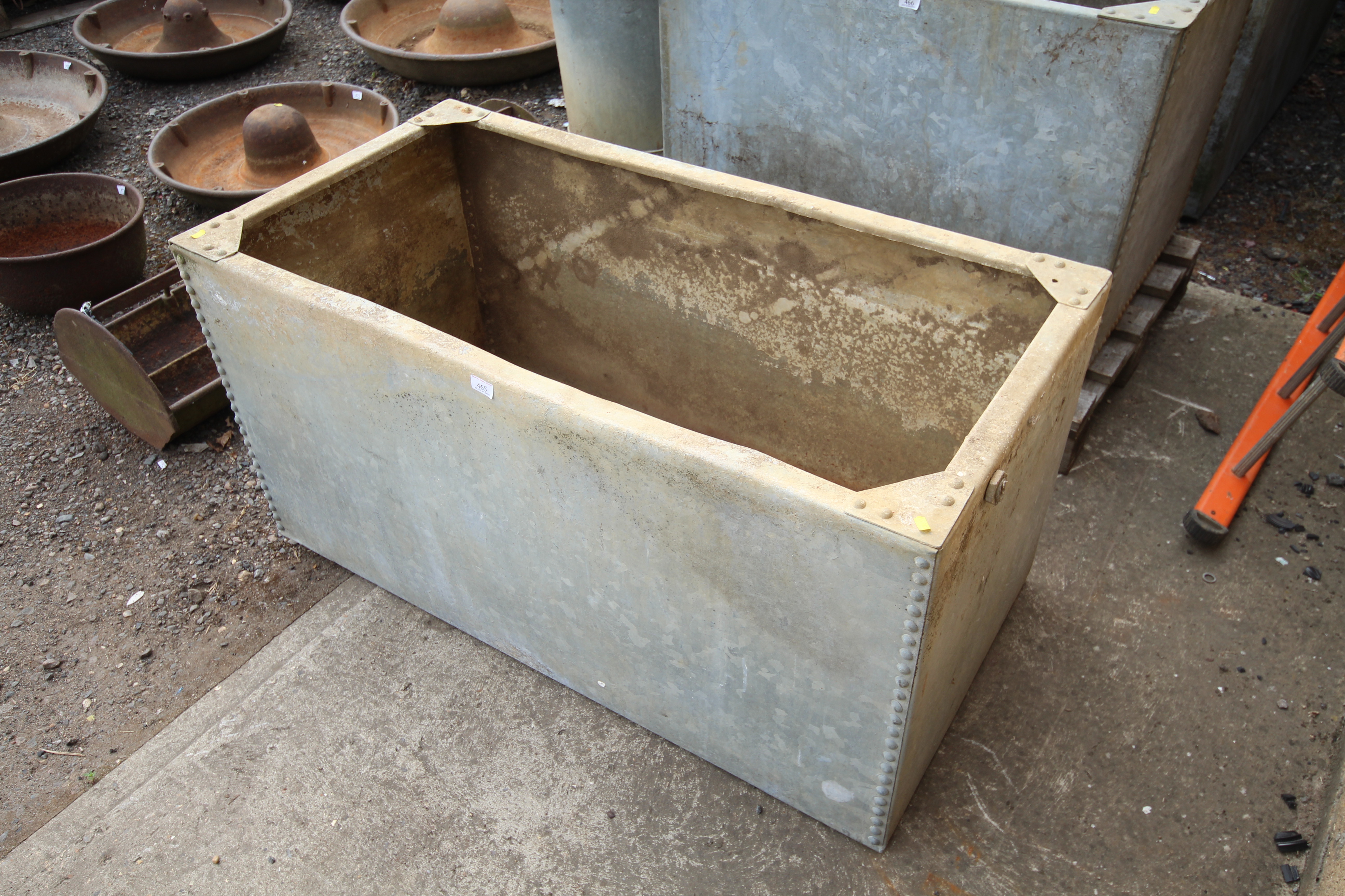 A galvanised riveted water tank, approx. 4' x 2' x 2'