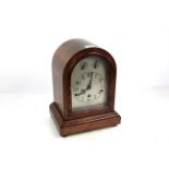 A mahogany cased three hole mantel clock