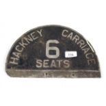 A vintage "Hackney Carriage" sign for six seats