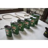 Six Castrol graduated oil cans