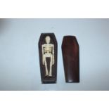 A small coffin and skeleton