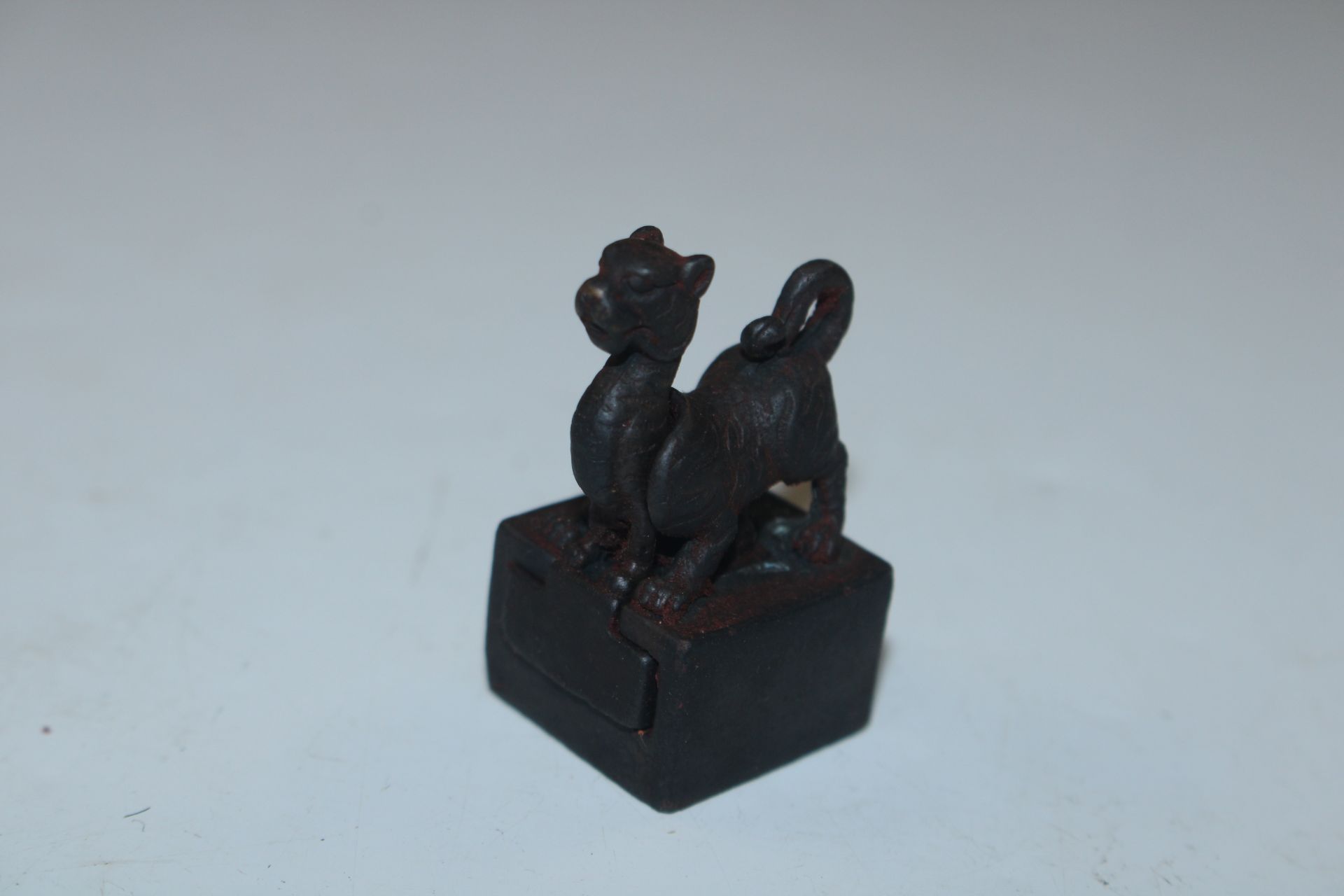 A small bronzed double dragon seal