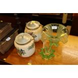 Two porcelain biscuit barrels and a green glass fl