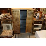 A vintage style metal cabinet with gilded doors