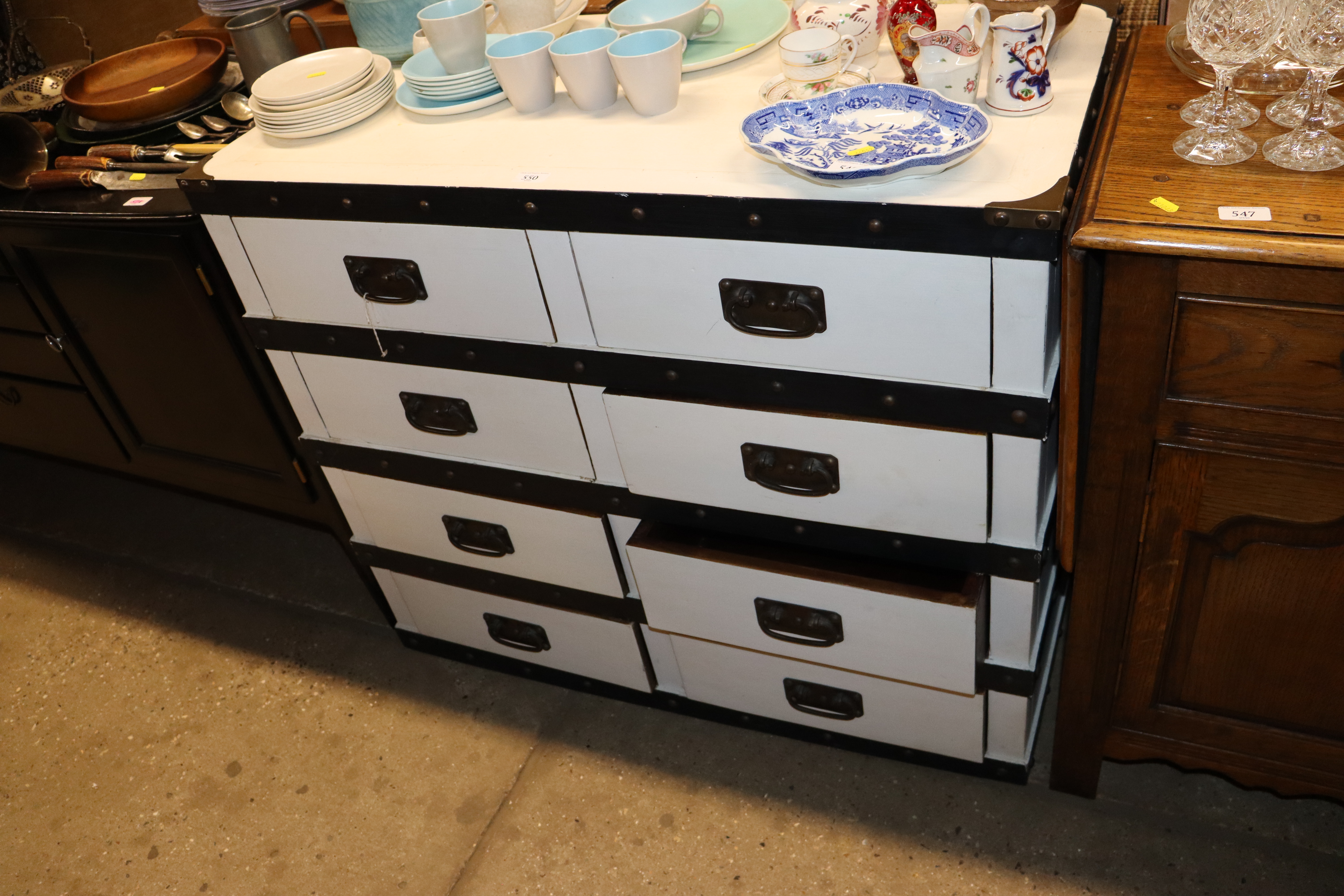 A white painted and metal bound chest of eight drawers
