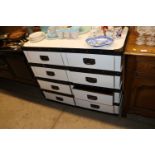 A white painted and metal bound chest of eight drawers