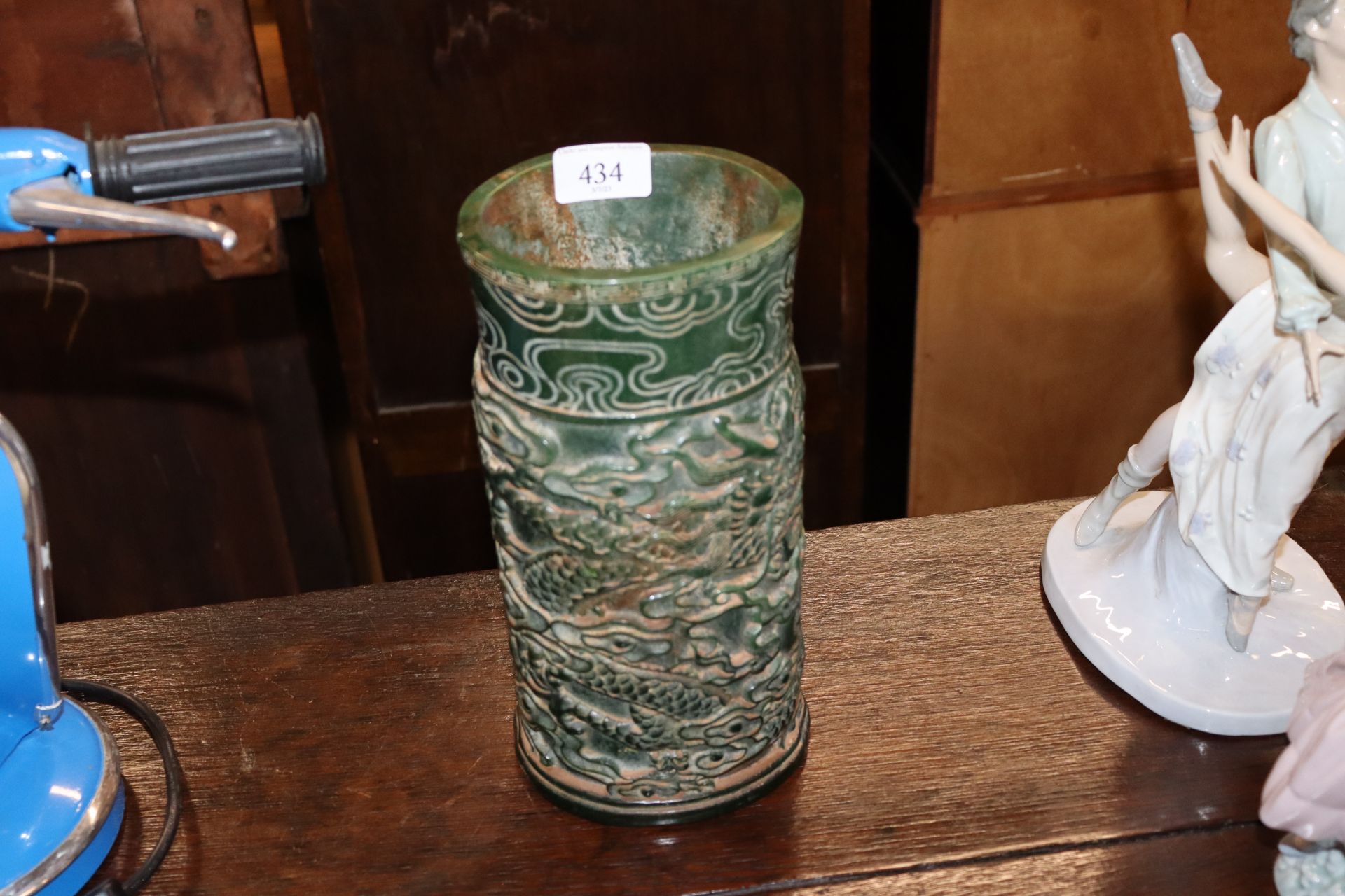 A green jade type brush pot with dragon decoration