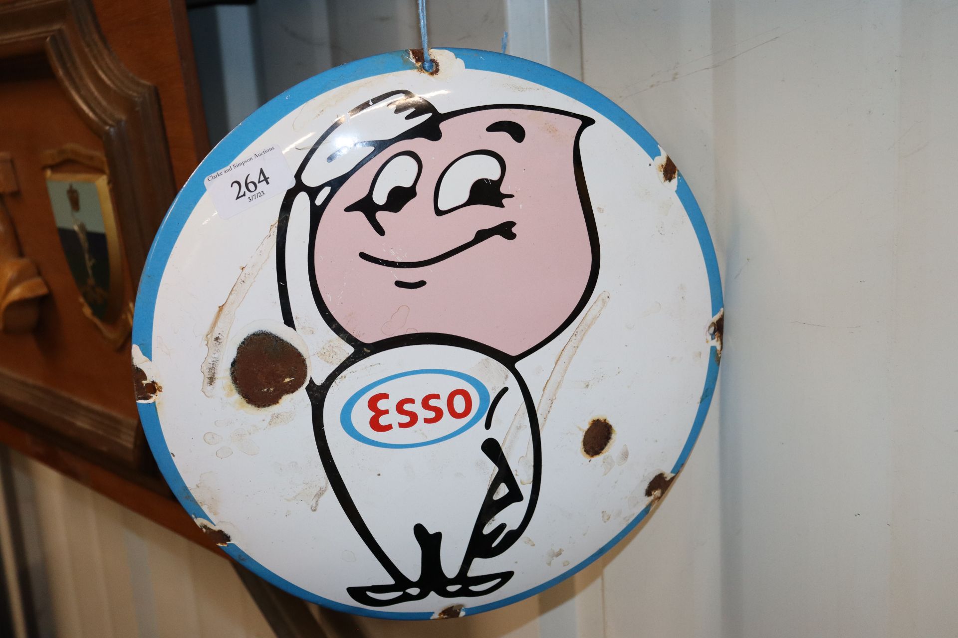 A circular Esso style enamel advertising sign