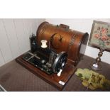 A vintage hand sewing machine with inlaid case