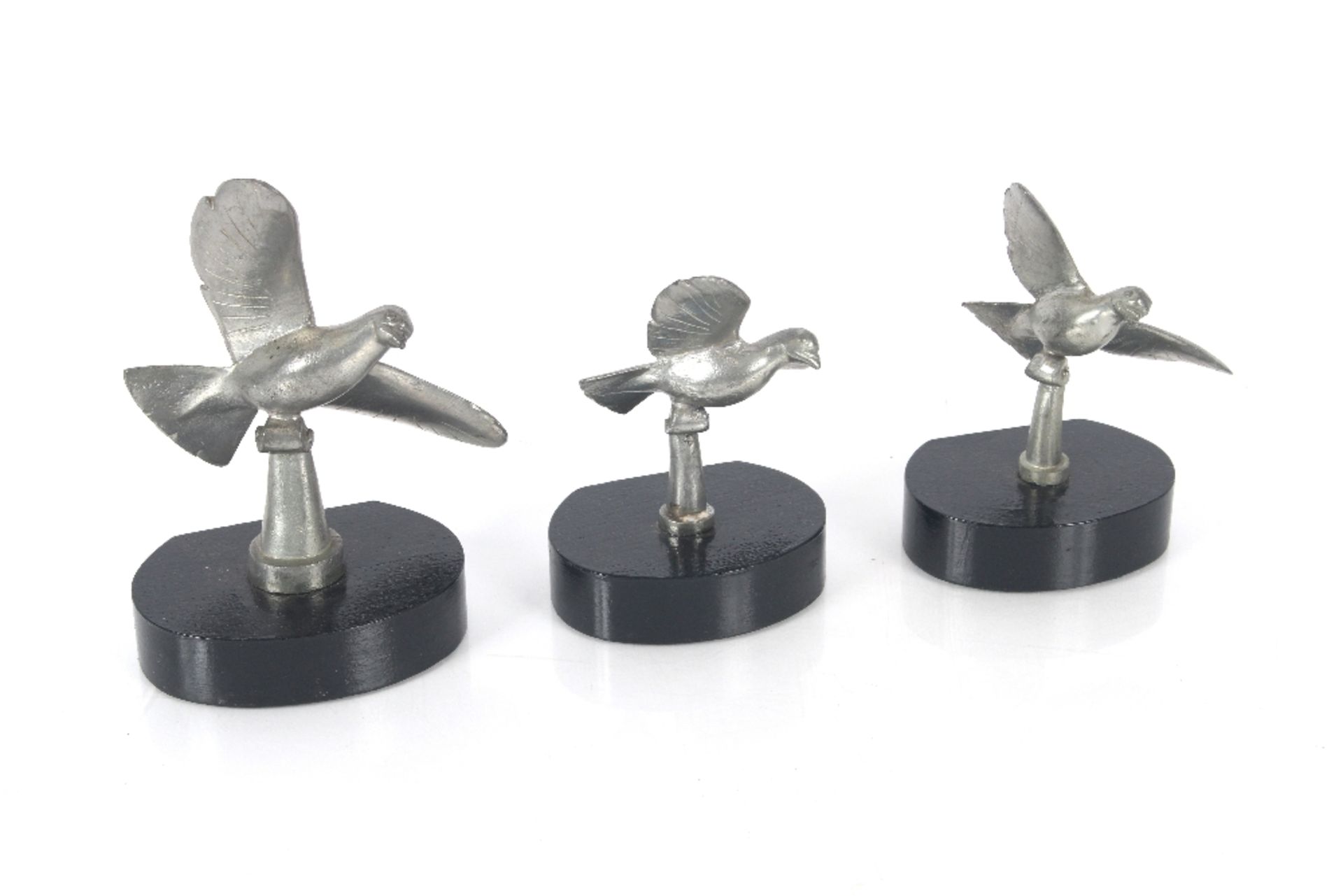 A set of three French plated bird ornaments raised