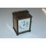 An antique brass carriage clock