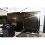 A Hitachi smart flat screen television with remote