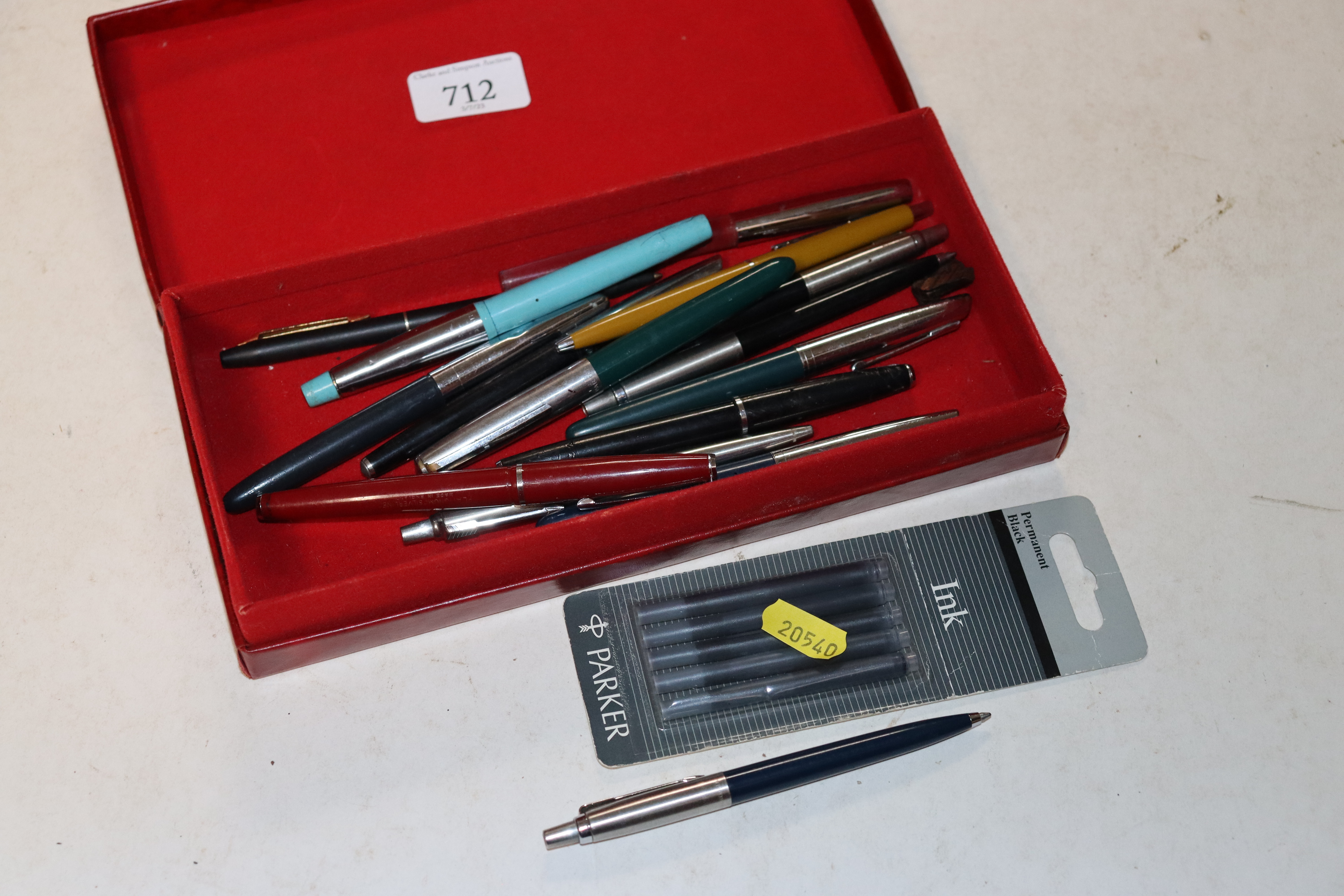 A box of various pens to include Parker and Cross