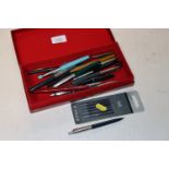 A box of various pens to include Parker and Cross